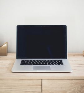 MacBook Pro on top of brown table