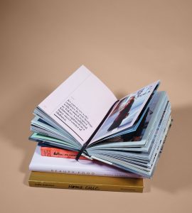 open book on top of several stacked books